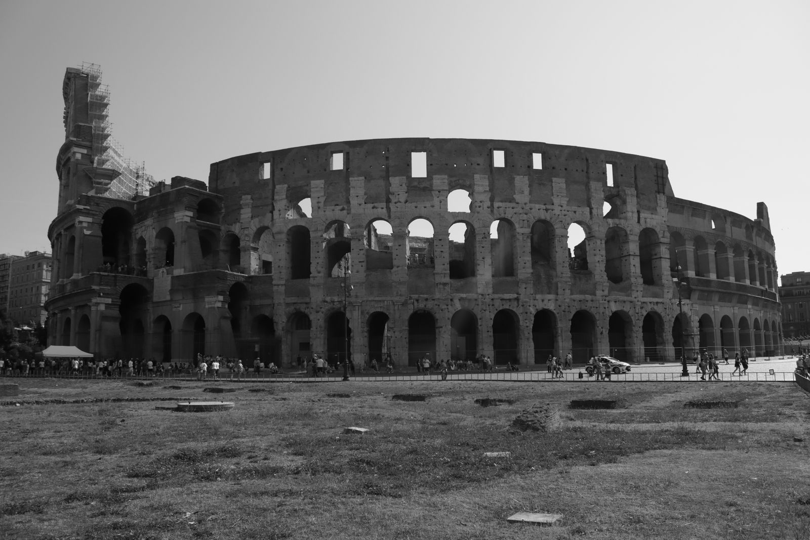 Striking black and white photograph of the iconic Colosseum in Rome, Italy, showcasing its historic architecture.